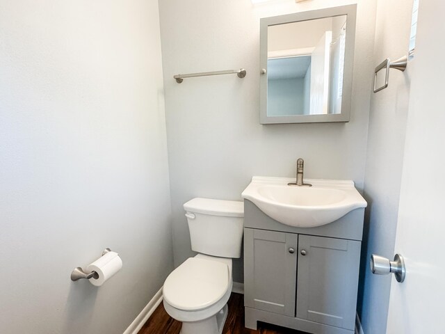 2255 Walden Dr, Augusta, GA 30904 - half bath featuring toilet, vanity, wood finished floors, and baseboards