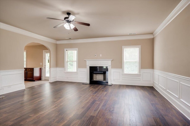 2083 Willhaven Dr, Augusta, GA 30909 - unfurnished living room featuring arched walkways, a ceiling fan, a fireplace with raised hearth, wainscoting, and dark wood-type flooring