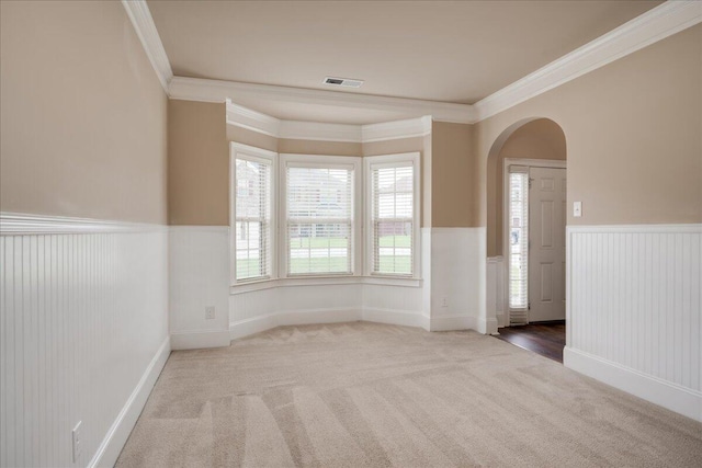 2083 Willhaven Dr, Augusta, GA 30909 - carpeted spare room with wainscoting, arched walkways, and ornamental molding