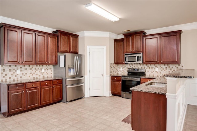 2083 Willhaven Dr, Augusta, GA 30909 - kitchen featuring appliances with stainless steel finishes, a sink, a peninsula, light flooring, and stone countertops