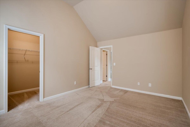 2083 Willhaven Dr, Augusta, GA 30909 - unfurnished bedroom featuring a spacious closet, light colored carpet, baseboards, a closet, and high vaulted ceiling