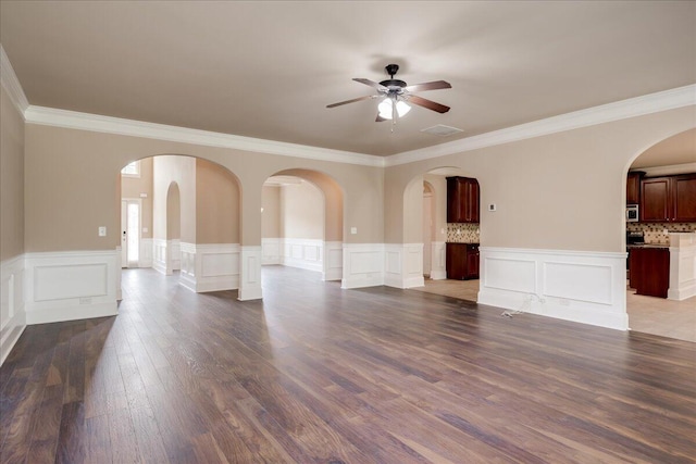 2083 Willhaven Dr, Augusta, GA 30909 - empty room featuring ceiling fan, ornamental molding, dark wood-style floors, a wainscoted wall, and a decorative wall