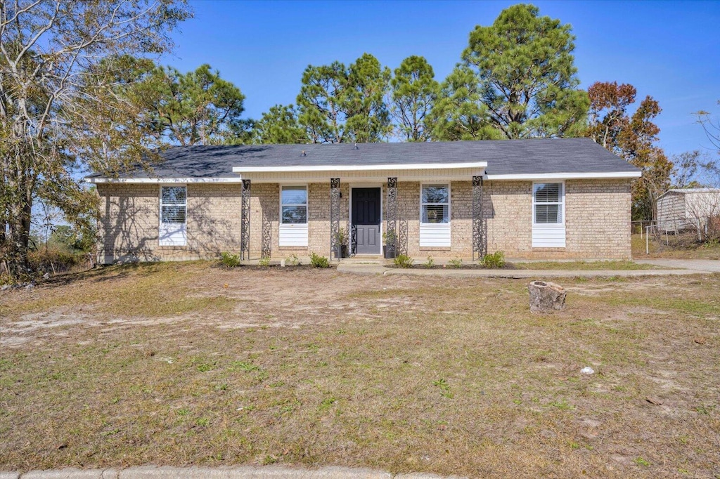 ranch-style home with a front lawn