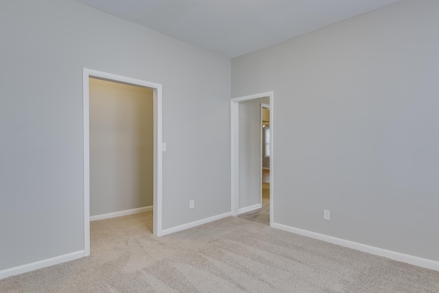 807 Crawford Ave, Augusta, GA 30904 - unfurnished bedroom with carpet flooring, baseboards, and a walk in closet