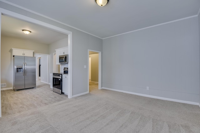 807 Crawford Ave, Augusta, GA 30904 - kitchen with appliances with stainless steel finishes, white cabinets, light colored carpet, ornamental molding, and baseboards