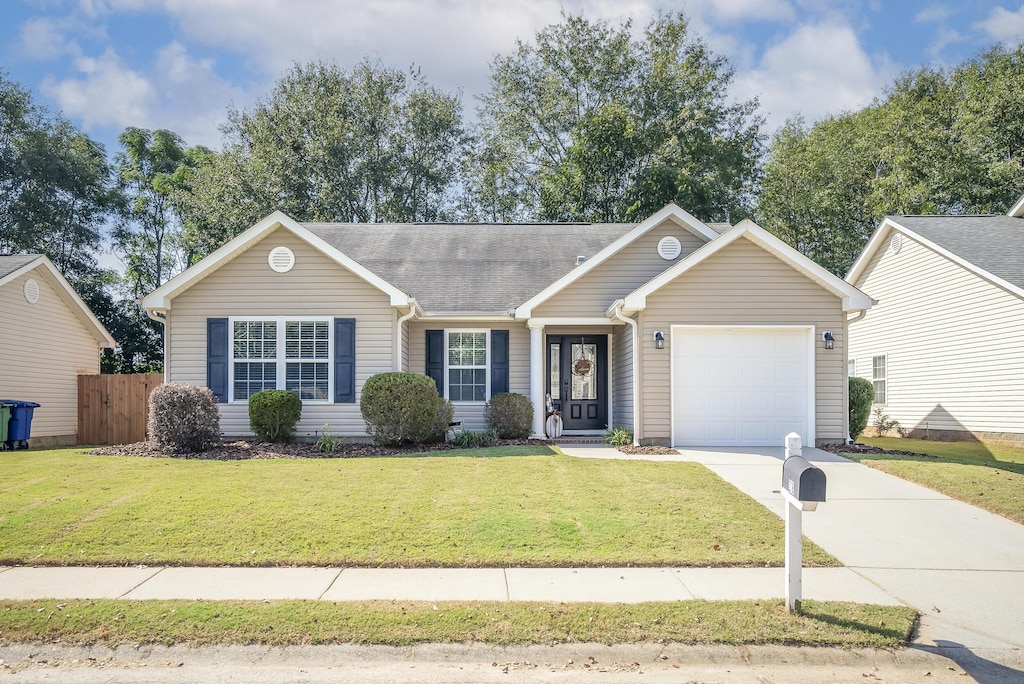 single story home featuring a front yard and a garage