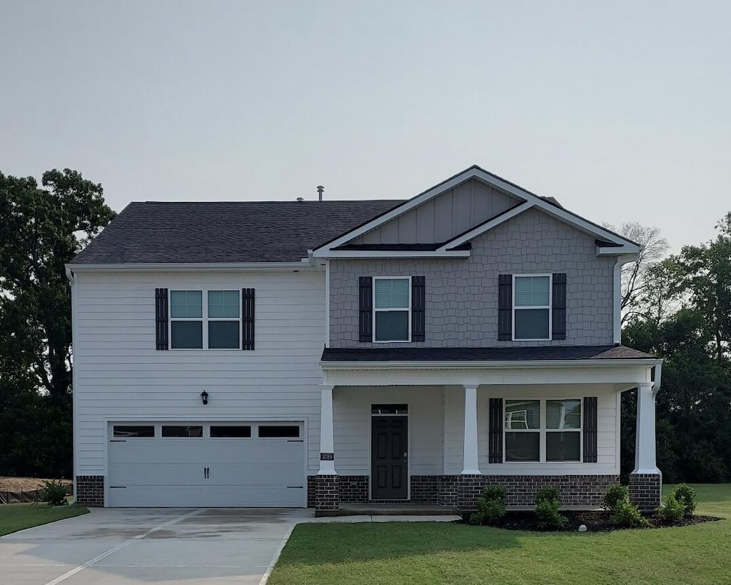 3089 Fancy Trl, Aiken, SC 29803 - view of front of house with a garage, covered porch, concrete driveway, and a front yard