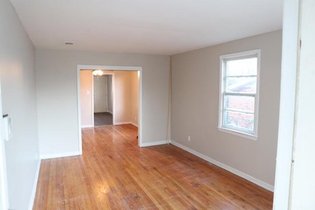 unfurnished room featuring light hardwood / wood-style floors and plenty of natural light