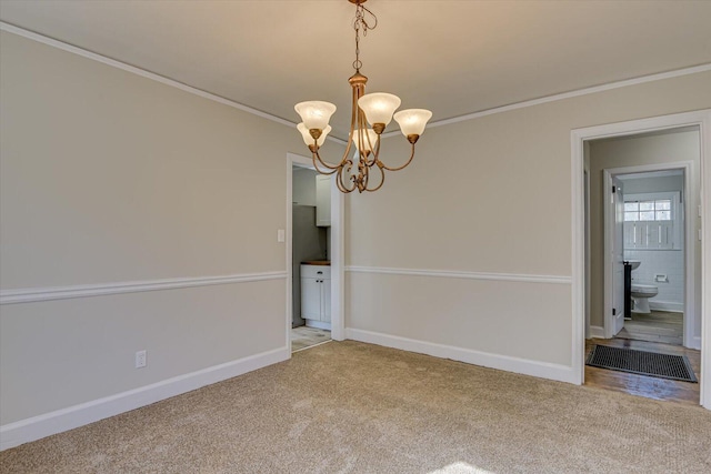 unfurnished room featuring a notable chandelier, ornamental molding, and light colored carpet