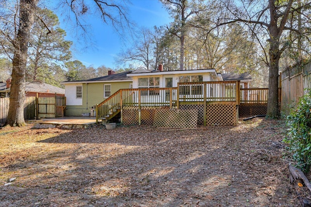 rear view of property with a wooden deck