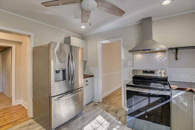 kitchen featuring appliances with stainless steel finishes, tasteful backsplash, extractor fan, ornamental molding, and white cabinets