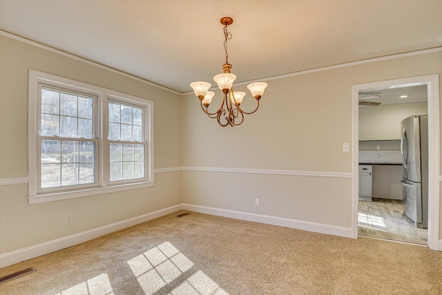 unfurnished room featuring crown molding, light colored carpet, and a chandelier