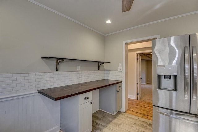 kitchen with wooden counters, white cabinetry, ornamental molding, light hardwood / wood-style floors, and stainless steel fridge with ice dispenser