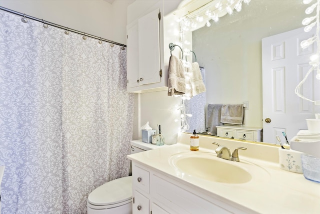 bathroom featuring curtained shower, vanity, and toilet