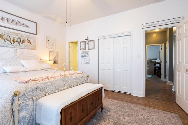 bedroom with a closet, baseboards, and wood finished floors