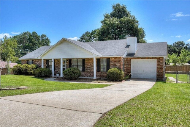 ranch-style home featuring covered porch, a front yard, and a garage