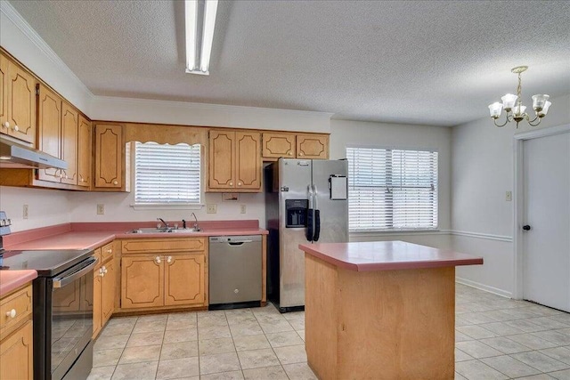 kitchen with a healthy amount of sunlight, hanging light fixtures, stainless steel appliances, a notable chandelier, and a kitchen island