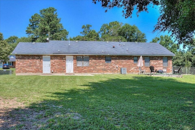 rear view of house with a yard