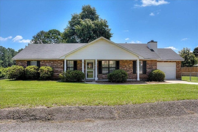 single story home featuring a garage and a front lawn