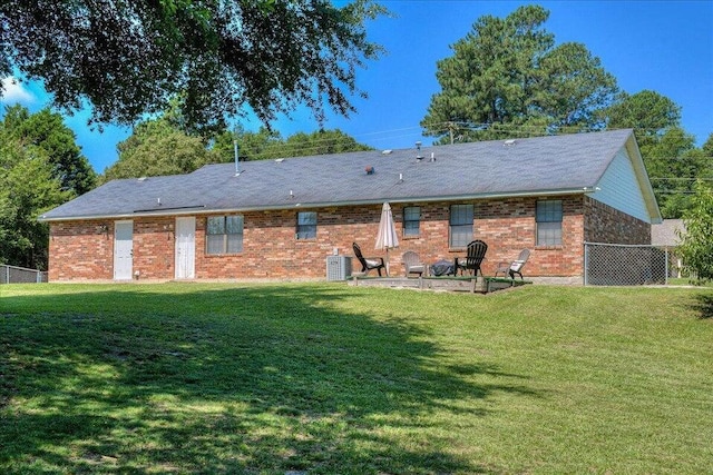 back of property with a yard and a patio area