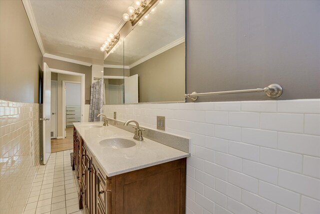 2408 Forest Park Rd, Augusta, GA 30904 - full bathroom with tile walls, double vanity, tile patterned floors, a wainscoted wall, and ornamental molding