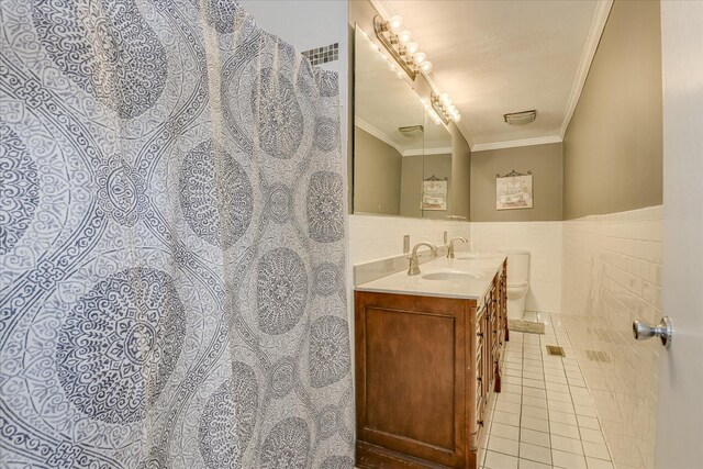 2408 Forest Park Rd, Augusta, GA 30904 - full bath featuring ornamental molding, tile patterned floors, vanity, tile walls, and wainscoting