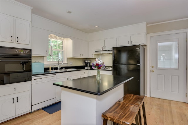 2408 Forest Park Rd, Augusta, GA 30904 - kitchen featuring black appliances, a sink, light wood-type flooring, white cabinetry, and dark countertops
