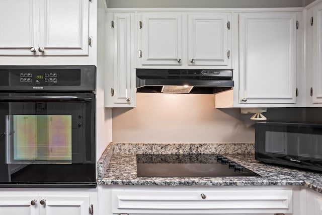 2901 Sussex Rd, Augusta, GA 30904 - kitchen with under cabinet range hood, black appliances, and white cabinets