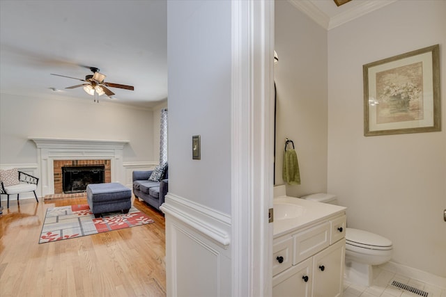 819 Cape Cod Ct, Evans, GA 30809 - bathroom with ceiling fan, vanity, crown molding, and a fireplace