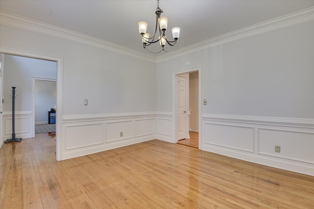 819 Cape Cod Ct, Evans, GA 30809 - empty room with a chandelier, light wood finished floors, crown molding, and a wainscoted wall