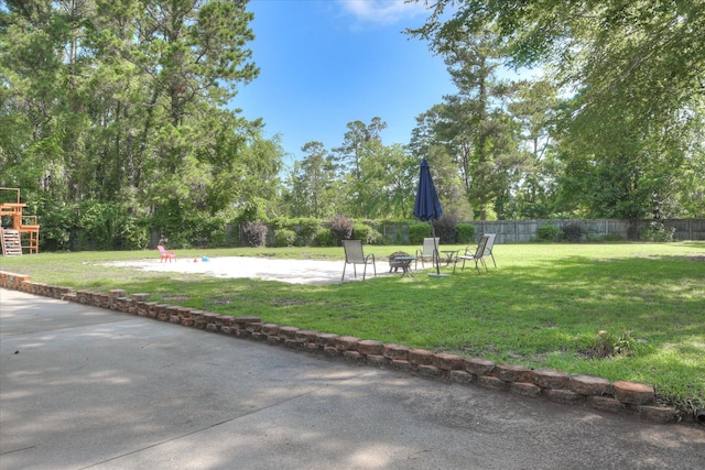 819 Cape Cod Ct, Evans, GA 30809 - view of yard with an outdoor fire pit, a patio, and view of wooded area