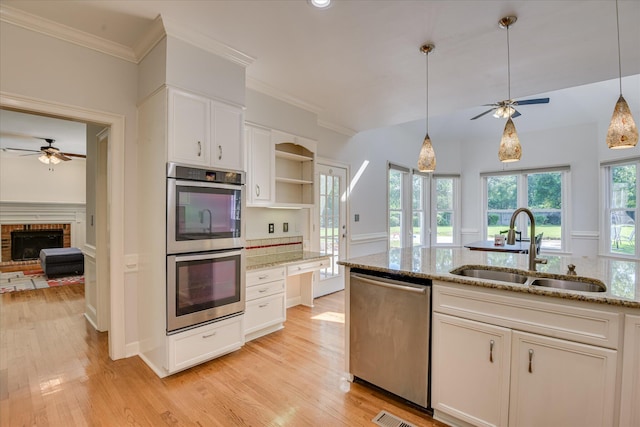 819 Cape Cod Ct, Evans, GA 30809 - kitchen with appliances with stainless steel finishes, a ceiling fan, open shelves, white cabinets, and crown molding