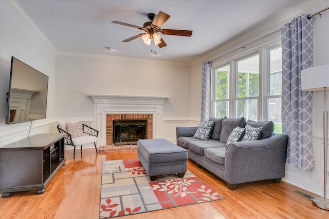 819 Cape Cod Ct, Evans, GA 30809 - living room with light wood finished floors, a ceiling fan, ornamental molding, a fireplace, and wainscoting