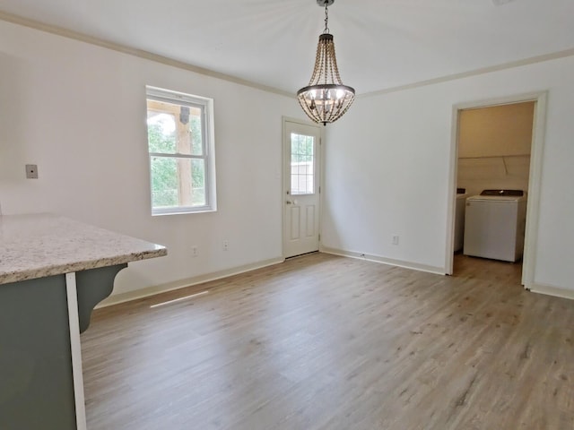 unfurnished dining area with baseboards, light wood finished floors, and a notable chandelier