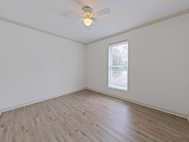 unfurnished room with crown molding, ceiling fan, baseboards, and light wood-style floors