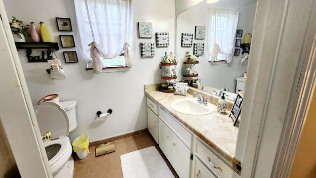 bathroom featuring tile patterned floors, toilet, and vanity