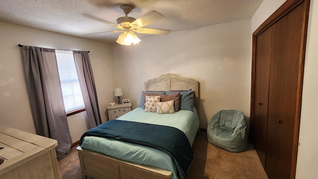 carpeted bedroom with a textured ceiling and ceiling fan