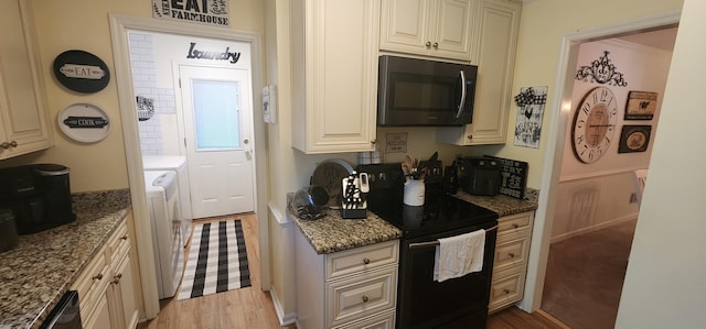 kitchen with black range with electric stovetop, washer / dryer, dark stone countertops, and light hardwood / wood-style floors