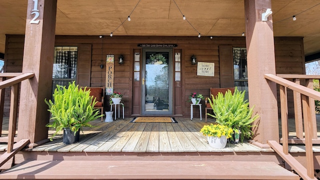 view of exterior entry with covered porch