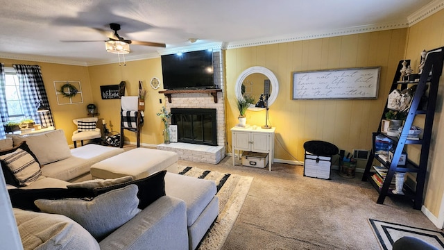 carpeted living area featuring a fireplace, baseboards, crown molding, and a ceiling fan