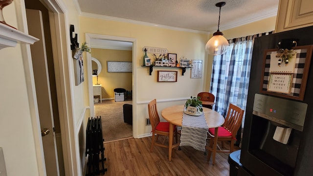 dining room featuring baseboards, a textured ceiling, dark wood-style floors, and crown molding