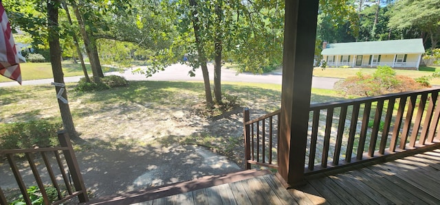 exterior space featuring a lawn and covered porch