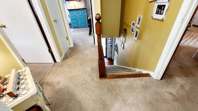 hallway with light colored carpet