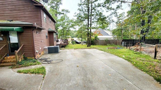 view of patio / terrace with central AC unit and a deck