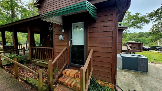 rear view of house featuring central AC unit and a deck