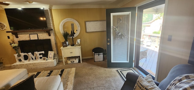 living room featuring baseboards, carpet, a fireplace, and crown molding