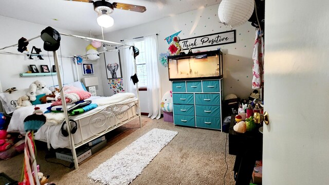 carpeted bedroom with ceiling fan and a textured ceiling