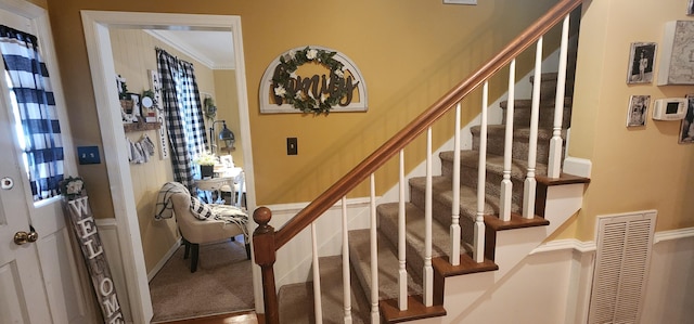 stairs featuring ornamental molding