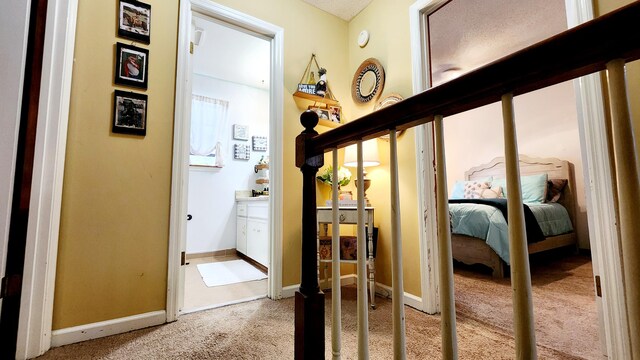 corridor with baseboards and carpet floors