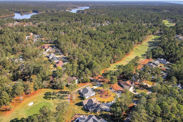 bird's eye view with golf course view, a view of trees, and a water view